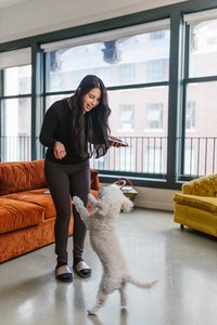 girl playing with dog 